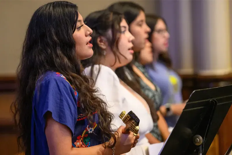 Five women of varying ethnicities sing at the Spanish Mass at the Basilica of the Sacred Heart.